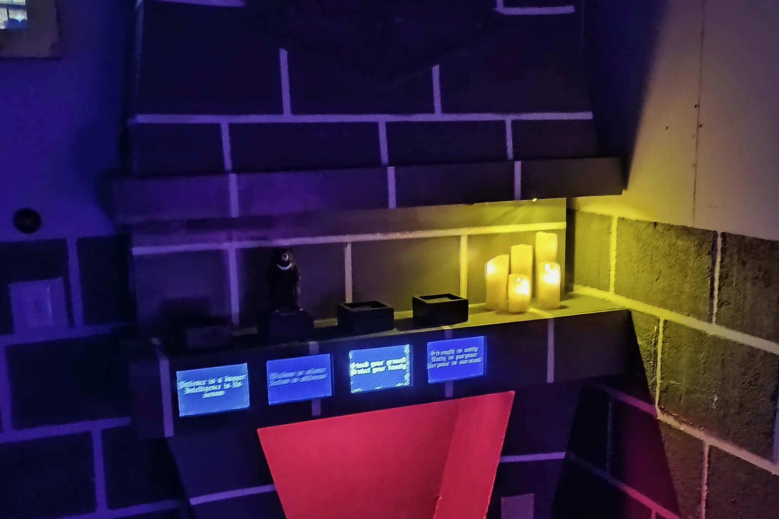 Academy of Magic fireplace illuminated with blue, yellow and red game lighting