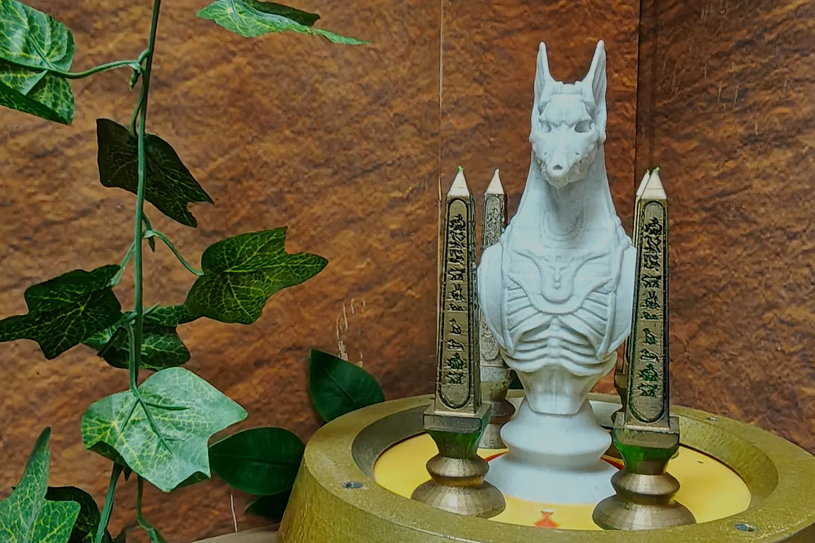An illuminated Anubis figure surrounded by vines inside The Alchemist