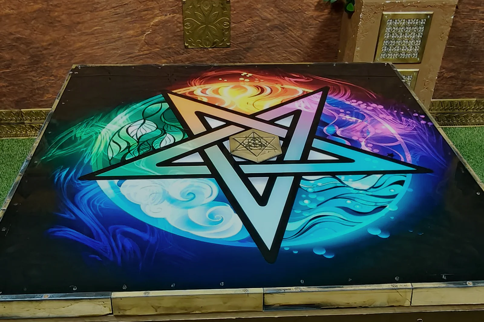 Illuminated elemental puzzle table inside The Alchemist escape room